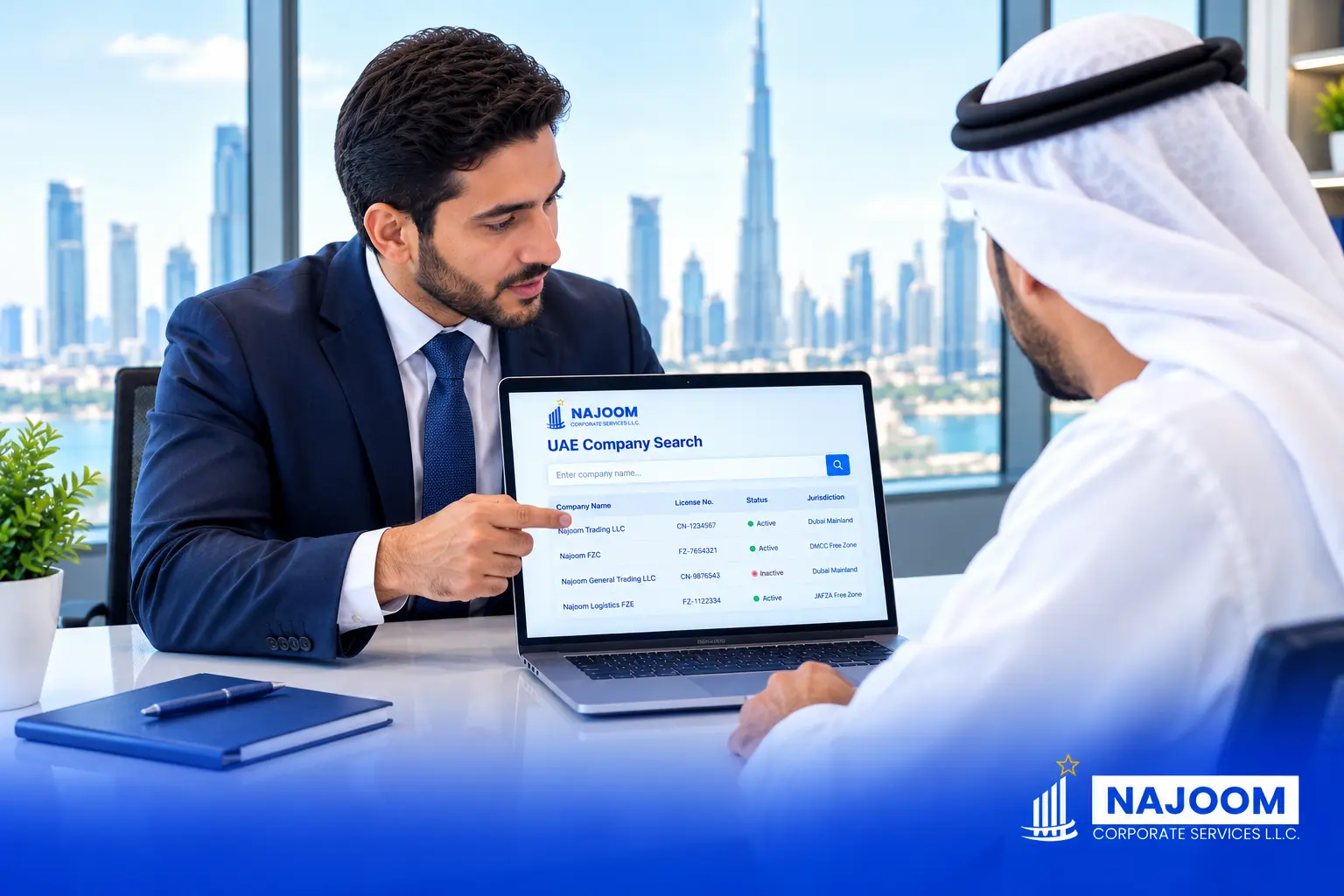 Business owner running a UAE company search by name on a laptop while a Najoom Corporate Services consultant explains the search results.